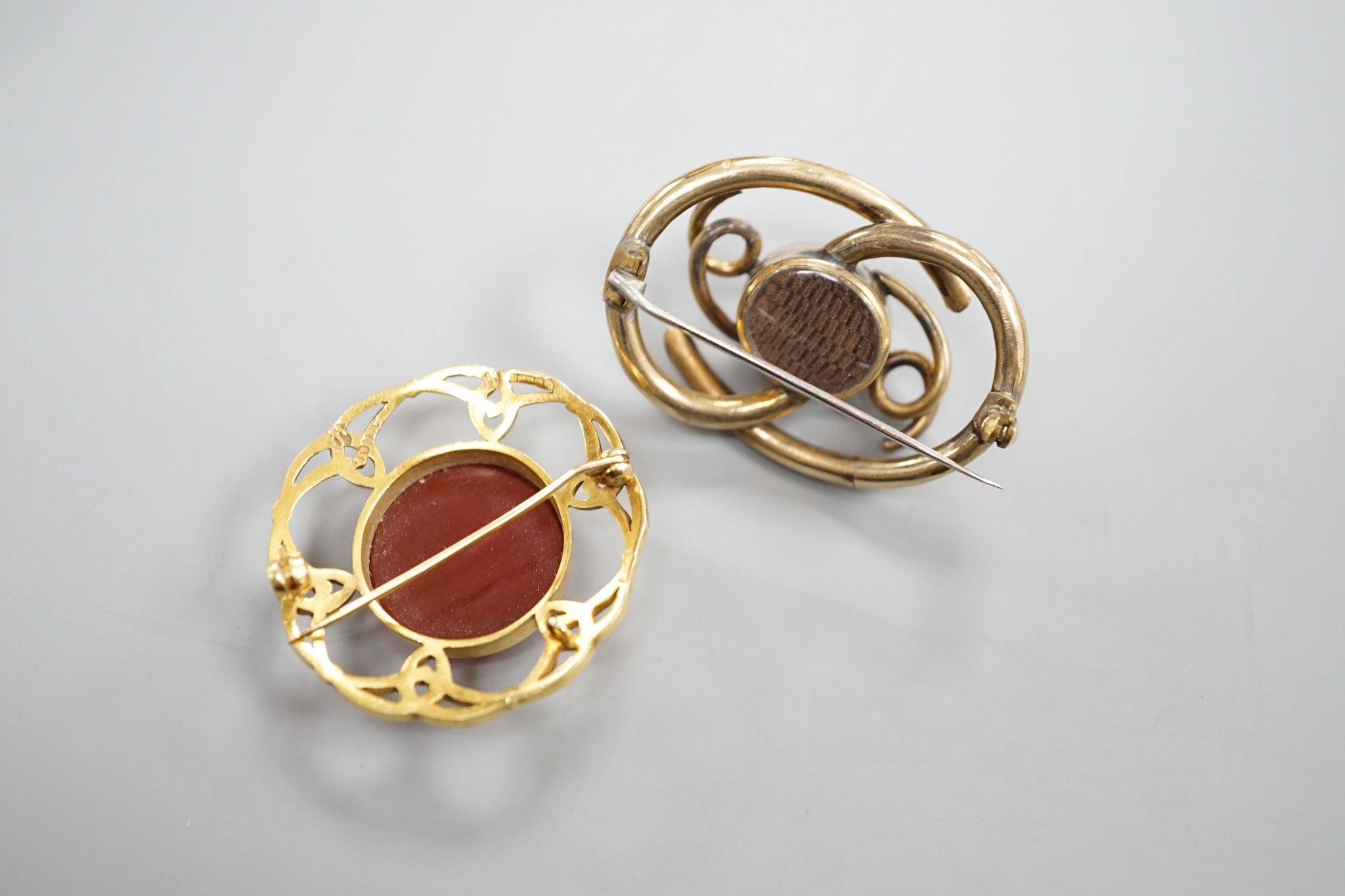A late Victorian Scottish 9ct gold and carnelian set Iona brooch, 36mm, gross 10.1 grams and a Victorian mourning brooch.